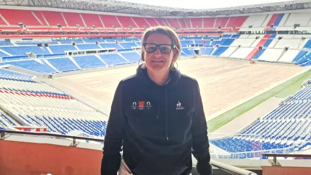 An Orange employee before a stadium