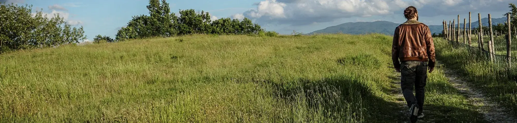 Un homme marche sur un chemin de campagne
