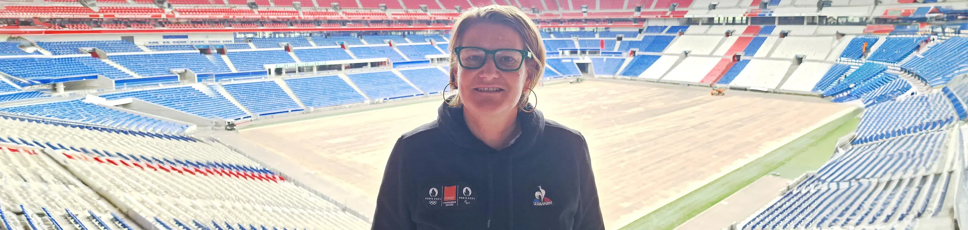 An Orange employee before a stadium