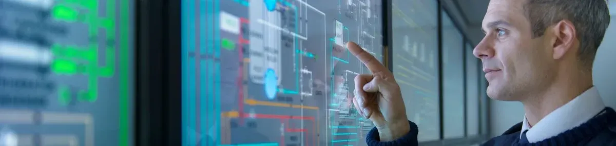 Homme regardant des données sur des écrans tactiles